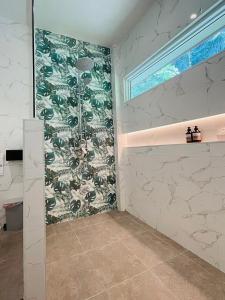 a shower in a bathroom with a tile wall at Tonsai Bay Resort in Tonsai Beach +103 photos
