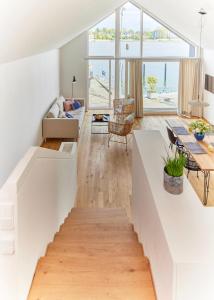 a living room with a staircase leading to the second floor at Netzschuppen in Kappeln +17 photos