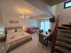 a bedroom with a bed and a living room at Anthemia Luxurious Villa in Iraklitsa
