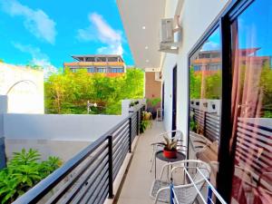 a balcony with a view of a building at Best Value Room Sanur Walk to Beach - NVB in Sanur