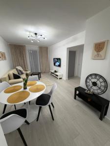 a living room with a table and chairs and a couch at White House in Ploieşti