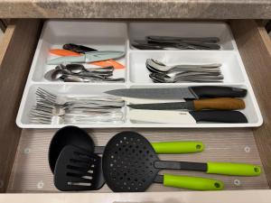 a drawer full of utensils in a drawer at White House in Ploieşti +9 photos
