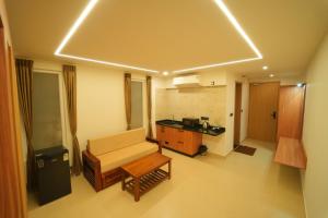 a living room with a couch and a table at Arunaragha in Mysore