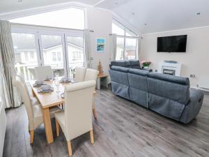 a living room with a table and a couch at Dono's Lodge in Narberth