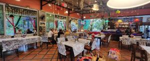 a restaurant with tables and chairs and people in it at Nubdao Resort&Restaurant in Nong Prue