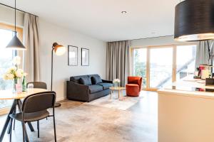 a living room with a couch and a table at Brera Meckenbeuren-Friedrichshafen in Meckenbeuren +32 photos