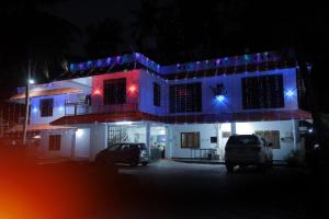 a house with christmas lights on top of it at Sun Shine Resort & Spa in Kovalam