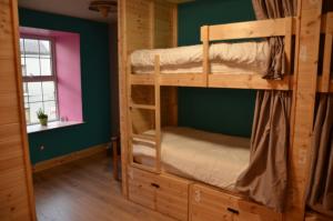 a room with two bunk beds in a cabin at The Black Sheep Hostel in Killarney
