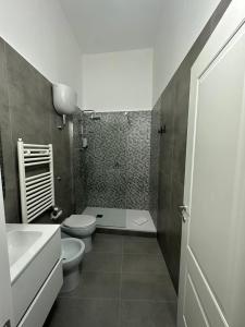 a bathroom with a toilet and a tub and a sink at Dimora del Corso in Caserta +11 photos