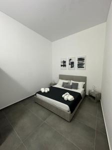 a bedroom with a bed with two towels on it at Dimora del Corso in Caserta