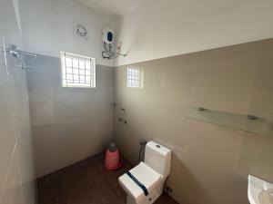 a bathroom with a toilet and a sink at Hotel serenity in Cochin