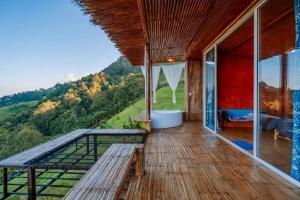 a balcony of a house with a view of the mountains at Mon Ngo misty haven B1 in Ban Mae Ta Man