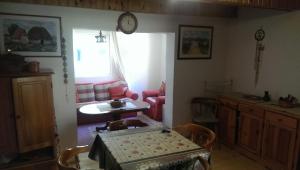 a living room with a table and a chair at Holiday Home Stella in Žabljak