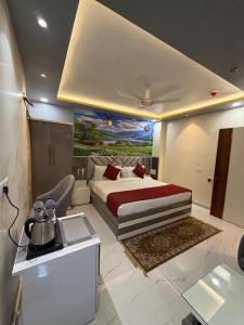 a bedroom with a bed and a painting on the wall at Hotel Aveda Paradise in Varanasi