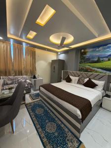 a bedroom with a large bed and a living room at Hotel Aveda Paradise in Varanasi +115 photos
