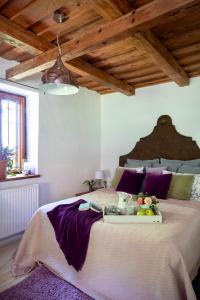 a large bed with a tray of fruit on it at PusztaFarm - Boutique Retreat with Wellness 6 to 8 Guests in Fülöpháza +31 photos