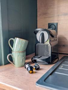 a coffee maker and a cup on a counter at L'émeraude Waulsort in Waulsort