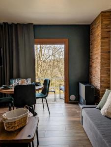 a living room with a table and a couch at L'émeraude Waulsort in Waulsort