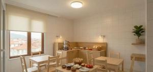a kitchen with a table and chairs and a window at Kaptanlar in Side