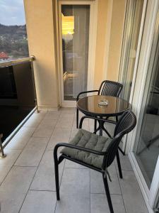 a table and chairs on a balcony with a table at White Horizon Apartment in Teslić