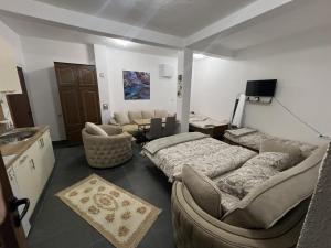 a living room with two beds and a couch at Household Grbovic in Bijelo Polje