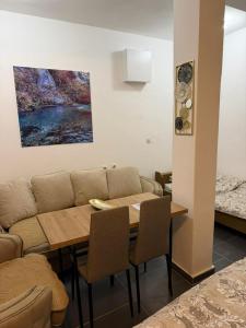 a dining room with a couch and a table at Household Grbovic in Bijelo Polje