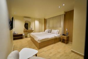 a hotel room with a bed and a mirror at Merak Pyramids Hotel in Cairo +167 photos