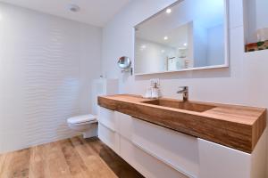 a bathroom with a sink and a toilet at Kolombage in Kientzheim +8 photos