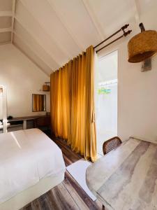 a bedroom with a bed and a large window at 101 Sosi in Kudafari