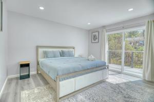 a bedroom with a bed and a large window at Modern Luxury Sierra Lodge | 3BR, 3BA | Hotel Vibe in Groveland