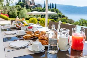 a table with pastries and drinks on top of it at Le Selve Lake View Villas in Toscolano Maderno