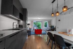 a kitchen and living room with a table and chairs at Spaanse Galeien 16 in Retranchement