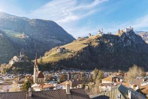 a view of a town with a mountain in the background at Apartment TrentaTre in Chiusa