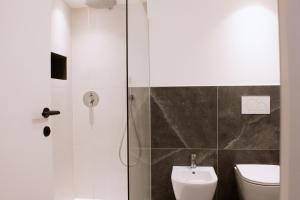a bathroom with a shower and a toilet at Apartment TrentaTre in Chiusa