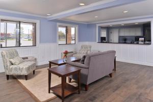 a living room with a couch and chairs and a table at Americas Best Value Inn & Suites-Birch Run in Birch Run