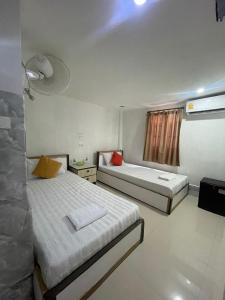 a bedroom with two beds and a window at Vientiane Star Hotel in Vientiane