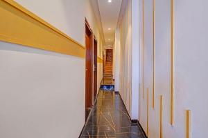 a hallway with a tiled floor and a staircase at FabHotel Beverly Plaza in Mumbai +19 photos