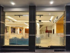 a store window with white tables and chairs at Hotel Maya Cottage' Newly Rebuilt 2026' Near New Delhi Railway Station & Connaught place in New Delhi