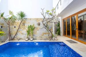 a swimming pool in a house with plants at Villa Surga in Denpasar +22 photos