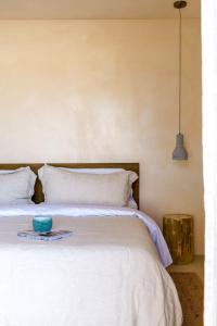 a white bed with a blue bowl on top of it at Sand Tulum Retreat w Pool Spa in Yucca Valley +41 photos