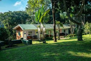 a house with a palm tree in front of a yard at Mon Kiang-Dao Resort in Chiang Dao +45 photos