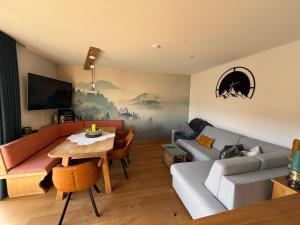 a living room with a couch and a table at Wohnung Kirchstein Highlight Fliegenfischen auf der Isar in Lenggries