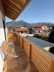 a wooden deck with a chair and a roof at Wohnung Kirchstein Highlight Fliegenfischen auf der Isar in Lenggries