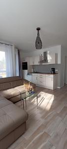 a living room with a couch and a table at Juliusruh Strandparadies 9 in Juliusruh
