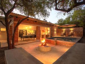 a backyard with a fire pit and a pool at Spoorzicht in Marloth Park