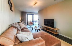 a living room with a couch and a flat screen tv at 5 Bedroom Beautiful Home In Oudenaarde in Oudenaarde
