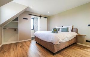 a bedroom with a large bed and a closet at 5 Bedroom Beautiful Home In Oudenaarde in Oudenaarde +32 photos