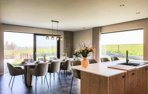 a dining room with a long table and chairs at 5 Bedroom Beautiful Home In Oudenaarde in Oudenaarde