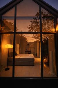a view of a bedroom through a window at Pruksa Place Udon Thani in Udon Thani