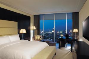 a bedroom with a bed and a desk and a large window at BREEV GWANGJU by LOTTE HOTELS, formerly Ramada Plaza by Wyndham Gwangju in Gwangju +9 photos